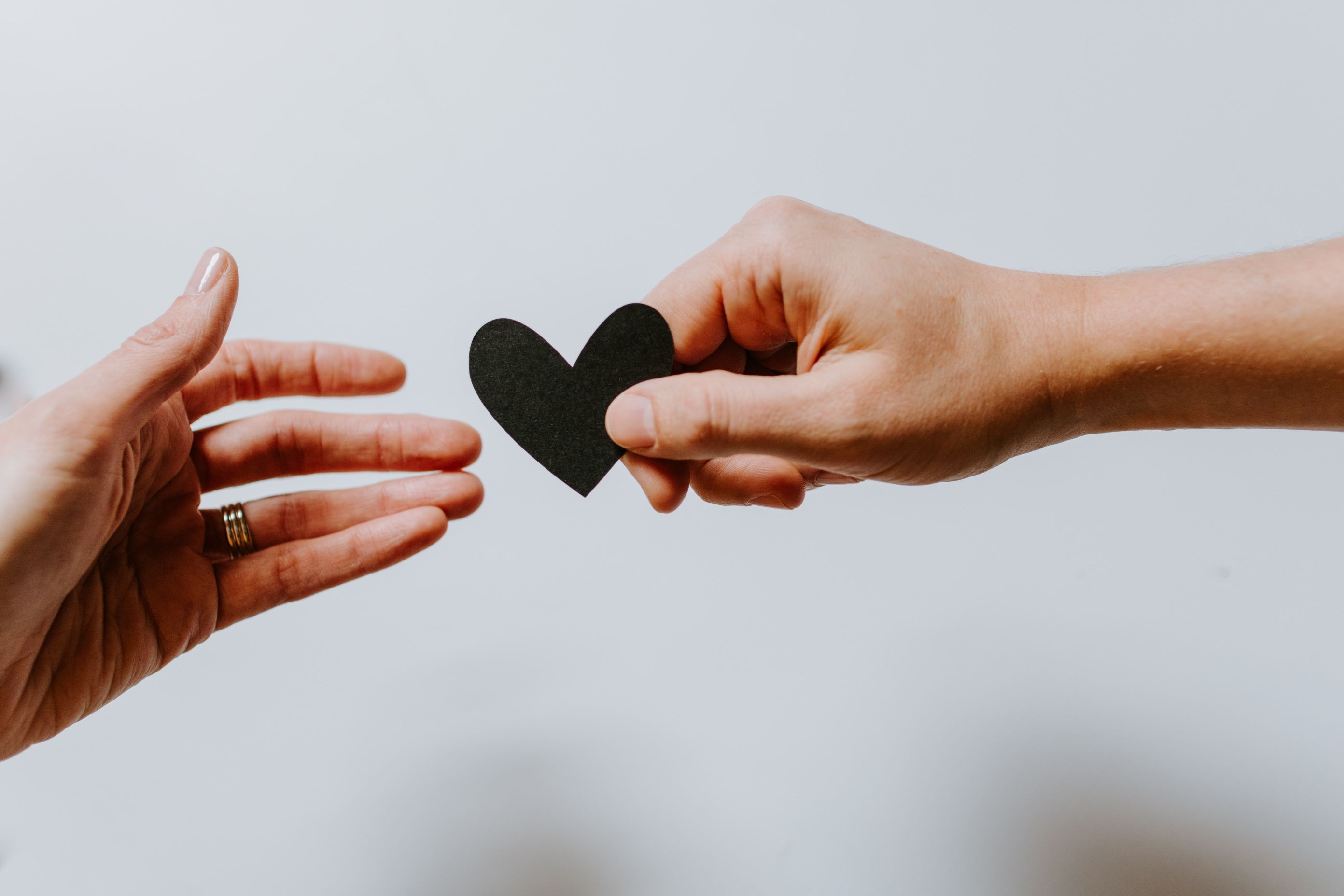 Person gifting a heart-shaped cutout