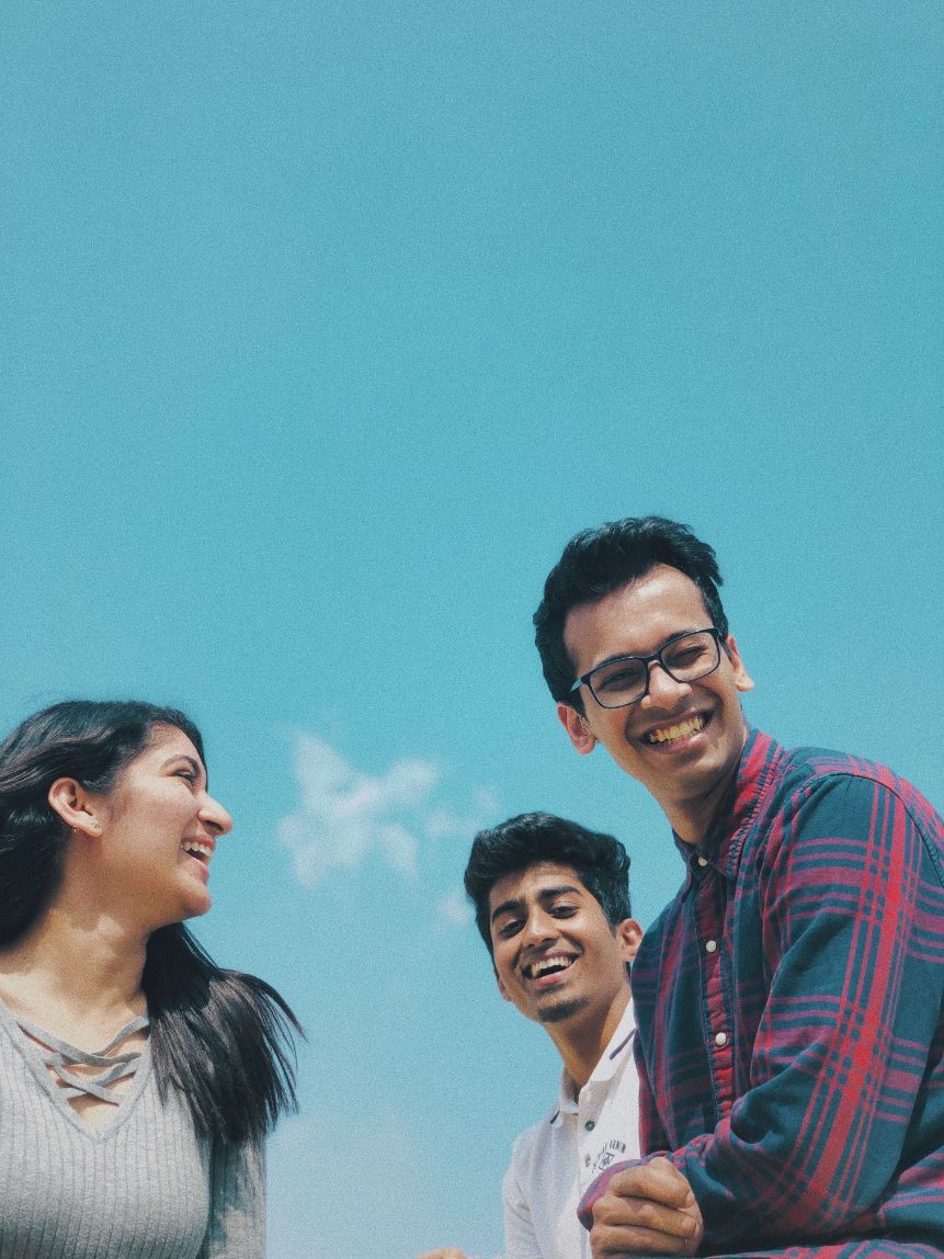 Three co-workers smiling and laughing